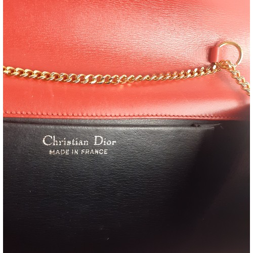 4 - Christian Dior- A 1960's/70's red flap over shoulder bag having a gold tone shoulder chain and gold ... 