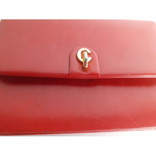 4 - Christian Dior- A 1960's/70's red flap over shoulder bag having a gold tone shoulder chain and gold ... 