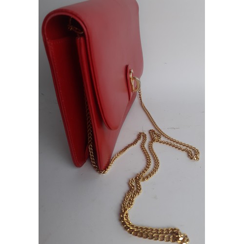 4 - Christian Dior- A 1960's/70's red flap over shoulder bag having a gold tone shoulder chain and gold ... 