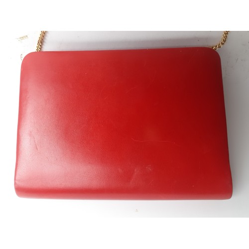 4 - Christian Dior- A 1960's/70's red flap over shoulder bag having a gold tone shoulder chain and gold ... 