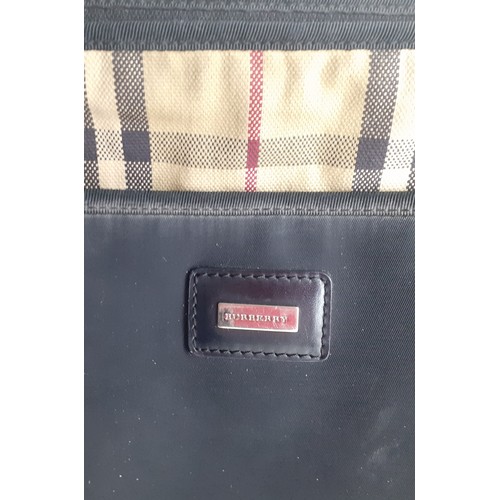 5 - Burberry- A large black canvas laptop bag with iconic cloth tartan lining and 3 zip closure and silv... 