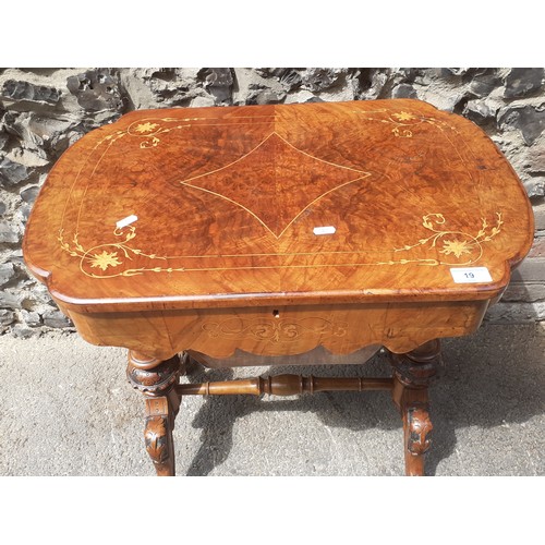 19 - A Victorian burr walnut marquetry inlaid work table having a hinged top and later fitted interior, 7... 