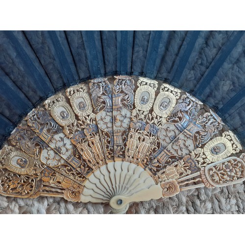 16 - An early 20th Century Chinese inspired fan having 14 composite cut-out wands in an Oriental design w... 