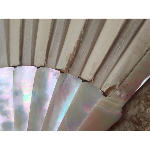 17 - An early 20th Century fan having 14 mother of pearl wands A/F having a cream silk and lace cut-out d... 