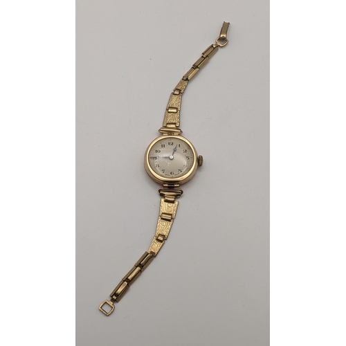 63 - An early 20th century ladies 9ct gold manual wind wristwatch on a gold plated strap
Location: CAB 8
... 