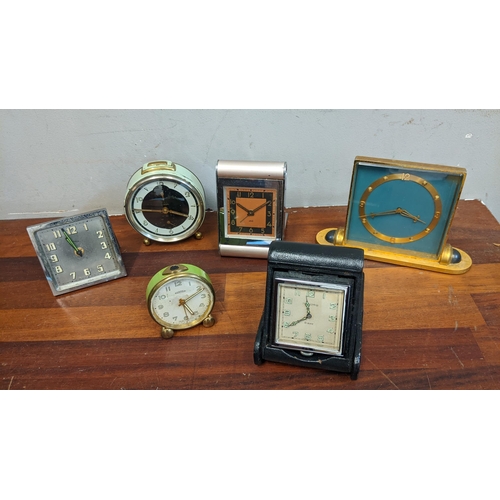 298 - Travel clocks to include a Mappin & Webb example in a leather case, alarm clocks and mantel clock
Lo... 