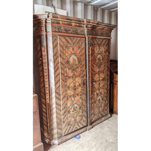 275 - A late 18th/early 19th century Swiss pine painted armoire, having a stepped cornice, painted with pa... 