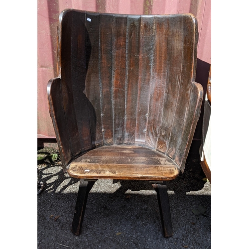 276 - An early 20th century oak chair made from a barrel, having wrought iron supports and block shaped le... 