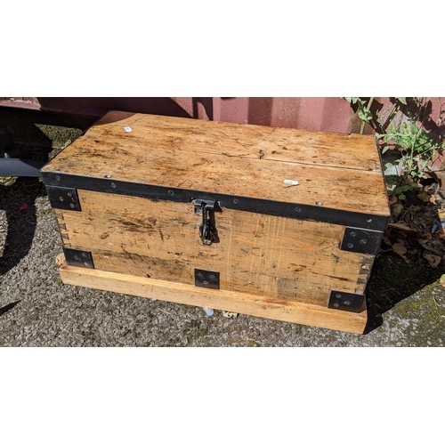 283 - A Victorian pine small chest having wrought iron supports and on a plinth base, 28cm high x 64cm wid... 