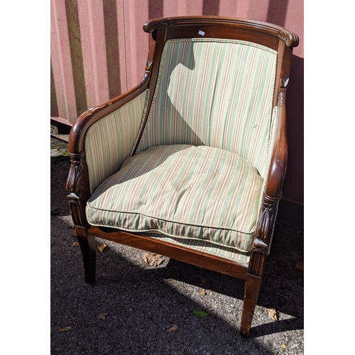 286 - A reproduction Empire style mahogany armchair having a scroll carved top and on square tapering legs... 