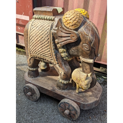 287 - An Indian teak carved model of an elephant mounted on a cart, 89cm high x 83cm wide
Location:RC
If t... 