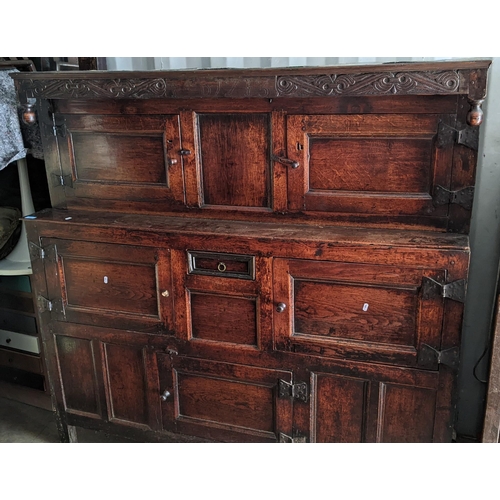 289 - An early 18th century oak court cupboard / didarn, dated 1713, having panelled doors, carved cornice... 