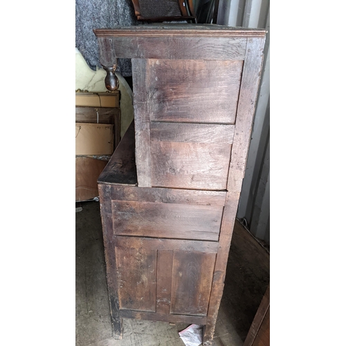 289 - An early 18th century oak court cupboard / didarn, dated 1713, having panelled doors, carved cornice... 