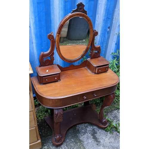 292 - A Victorian mahogany Duchess dressing table, having a swing mirror above drawers and an under tier s... 