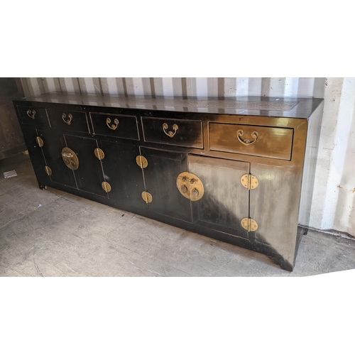 293 - An oriental black lacquered sideboard having five drawers above four cupboard doors, 81cm high x 221... 