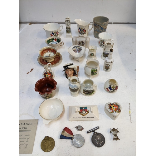 306 - A collection of Crestware to include various examples of the National exhibitions at Wembley, London... 