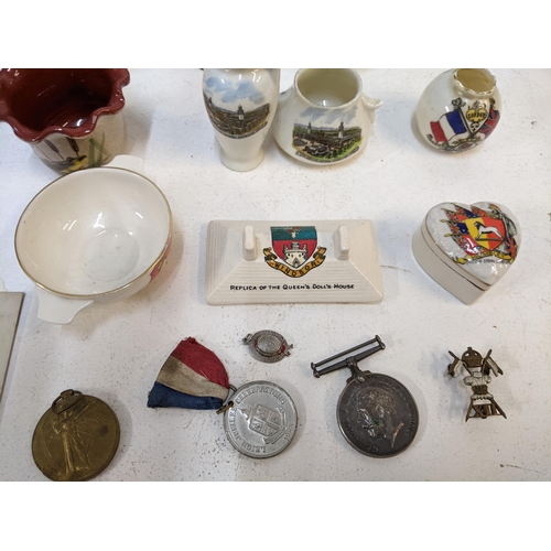 306 - A collection of Crestware to include various examples of the National exhibitions at Wembley, London... 