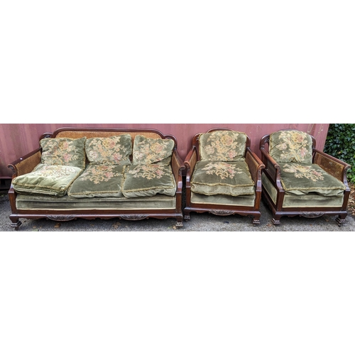 327 - An early 20th century Bergere three piece suite, the mahogany frames having scrolled arms, cloud sha... 