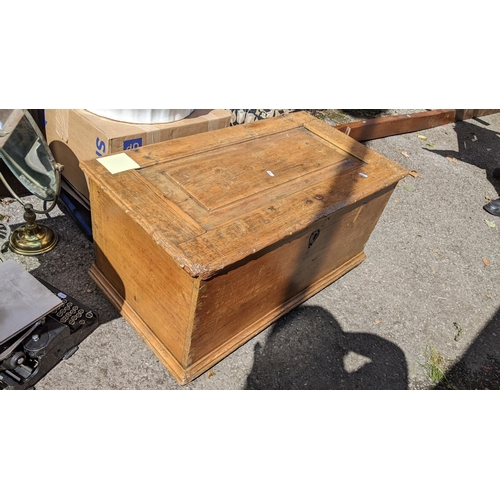 328 - A Victorian pine blanket box having a panelled hinged top and on a plinth base, 44cm high x 88cm wid... 