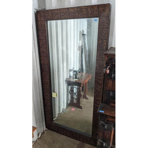 330 - A large rectangular wall hanging mirror, the frame having repeating square motifs and inset with bev... 