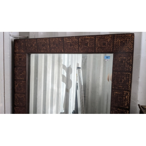 330 - A large rectangular wall hanging mirror, the frame having repeating square motifs and inset with bev... 