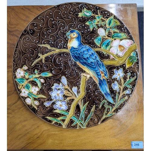 305 - A large Gebruder Schuty Austrian majolica decorative charger depicting an exotic bird (parrot) sitti... 