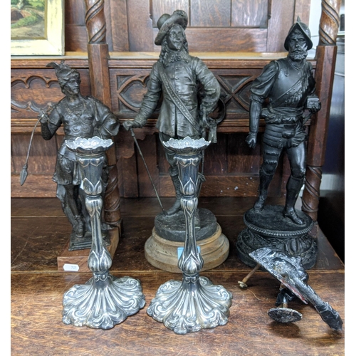 308 - Metalware to include three spelter figures, a pair of 19th century candlesticks and an Egyptian mask... 