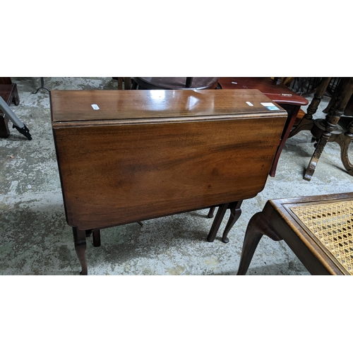 261 - An early 20th century mahogany Sutherland table on cabriole legs a small floor standing three shelf ... 