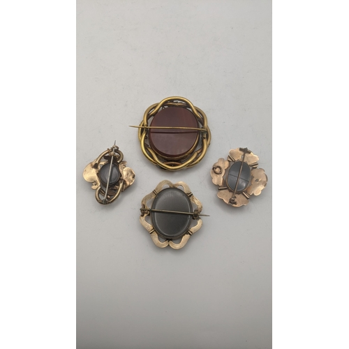 61 - Four Victorian mourning brooches to include three two sided brooches and the other mounting a pictur... 