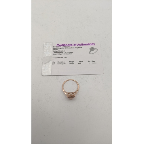 77 - A 10k rose gold ladies ring set with a triangular pink morganite, size S, 1.9g, with a certificate o... 