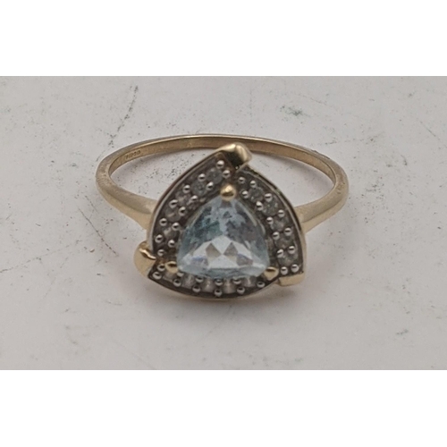 78 - A 9ct gold ring set with a triangular Pedra Azul aquamarine and white zircon, size Q, 2.2g with a ce... 