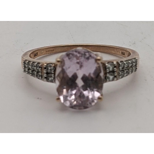 79 - A 9ct rose gold ring set with an oval Mawi kunzite flanked by white zircons size Q, 2.9g with a cert... 