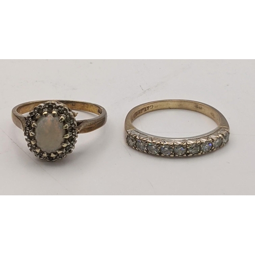 97 - Two 9ct gold rings to include an opal and diamond ring, size O, together with 9ct gold and paste sto... 