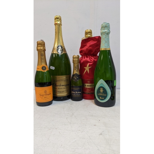 36 - Four bottles of Champagne and one bottle of Charlemagne 1500ml to include Veuve Clicquot Ponsardin B... 