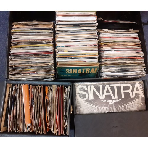 227 - A quantity of mainly 1970's and 80's 45rpm singles all housed in a shallow black case and a record c... 