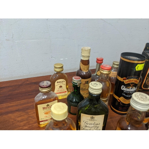 64 - Twenty one miniature bottles to include Gordon's Gin, Famous Grouse, Bells, Glenfiddich, and Grants.... 