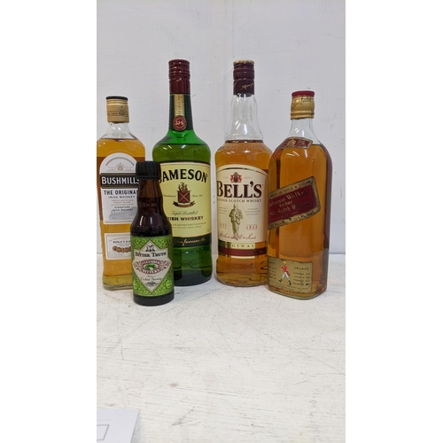 88 - Four bottles of Whisky to include  Bushmills, Jameson, Bells, Johnnie Walker.
Location:3, wooden she... 