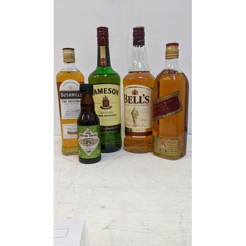 88 - Four bottles of Whisky to include  Bushmills, Jameson, Bells, Johnnie Walker.
Location:3, wooden she... 