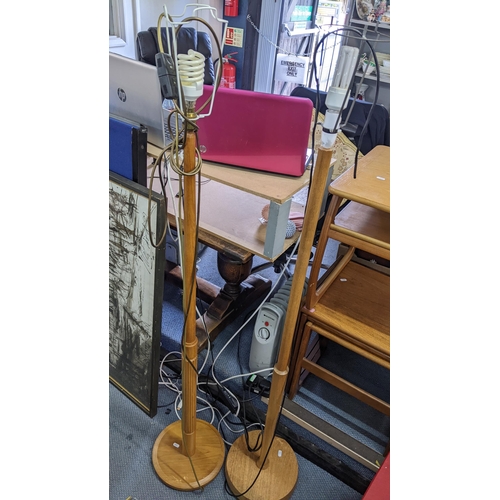 505 - Two mid 20th century teak standard lamps together with a two tier side table, a G-plan nest of three... 