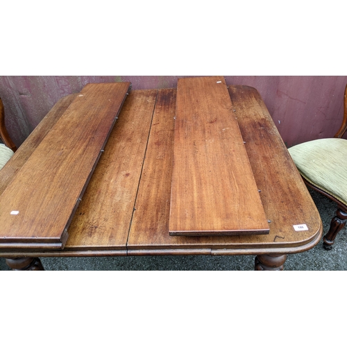 532 - A Victorian mahogany extending dining table, two additional leaves, on turned reeded legs and castor... 