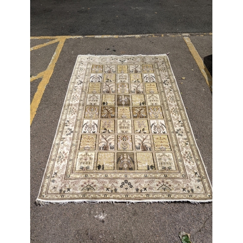 497 - A silk Turkish Hereke rug, the garden design, depicting different symbols and emblems in a 5x8 grid,... 