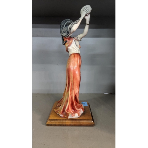 511 - A figure of a gypsy dancer with a tambourine, on a square wooden plinth by Giuseppe Armani, Florence... 