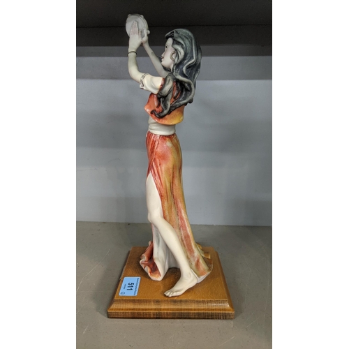 511 - A figure of a gypsy dancer with a tambourine, on a square wooden plinth by Giuseppe Armani, Florence... 