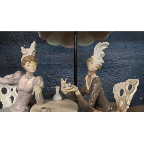 512 - A large Lladro 'Cafe de Paris' figure group depicting two ladies having a cup of tea under a parasol... 