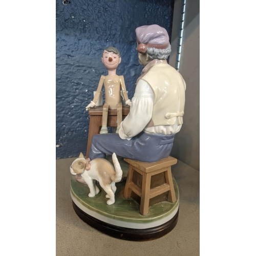 513 - A Lladro porcelain figure group of The Puppet Painter (Pinocchio) designed by Salvatore Furiosse, No... 