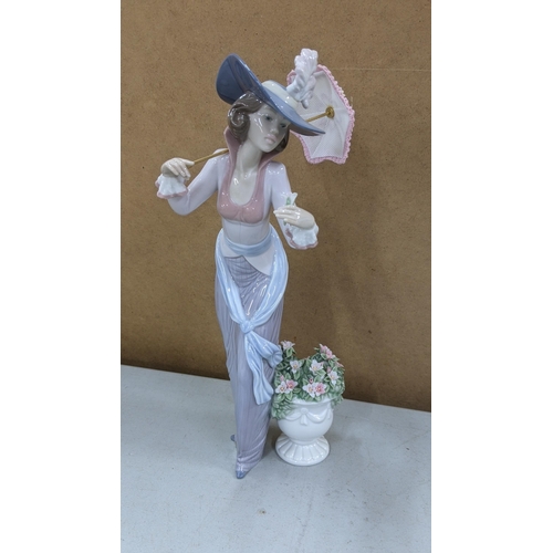 545 - Three Lladro figures to include Jolie opening her parasol No 5210, Flowers of Paris No 6279 and Grac... 