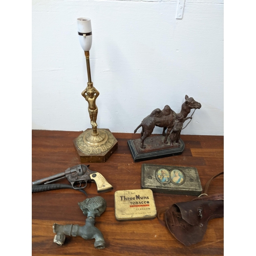 546 - Collectables to include a brass garden tap in the form of a hedgehog, a brass lamp base, a spelter c... 