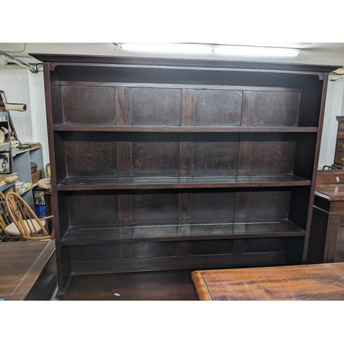 558 - An early to mid 20th century oak dresser, three open plate shelves above a base of two short drawers... 