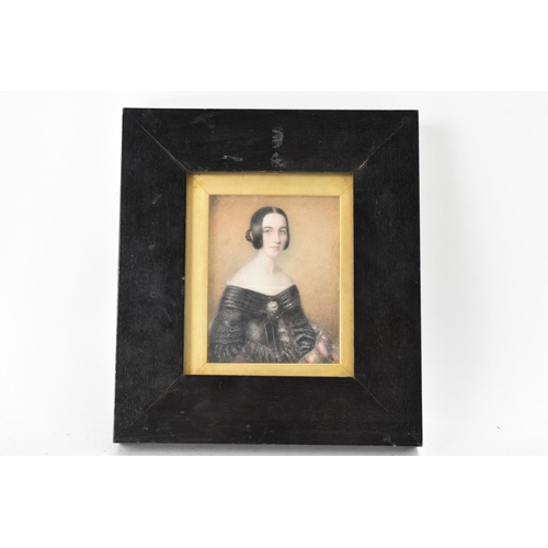 102 - A 19th century portrait miniature on ivory depicting a lady in a black dress, inscribed to the rever... 