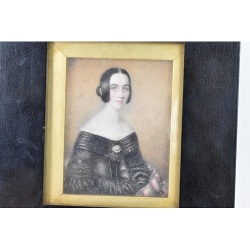 102 - A 19th century portrait miniature on ivory depicting a lady in a black dress, inscribed to the rever... 